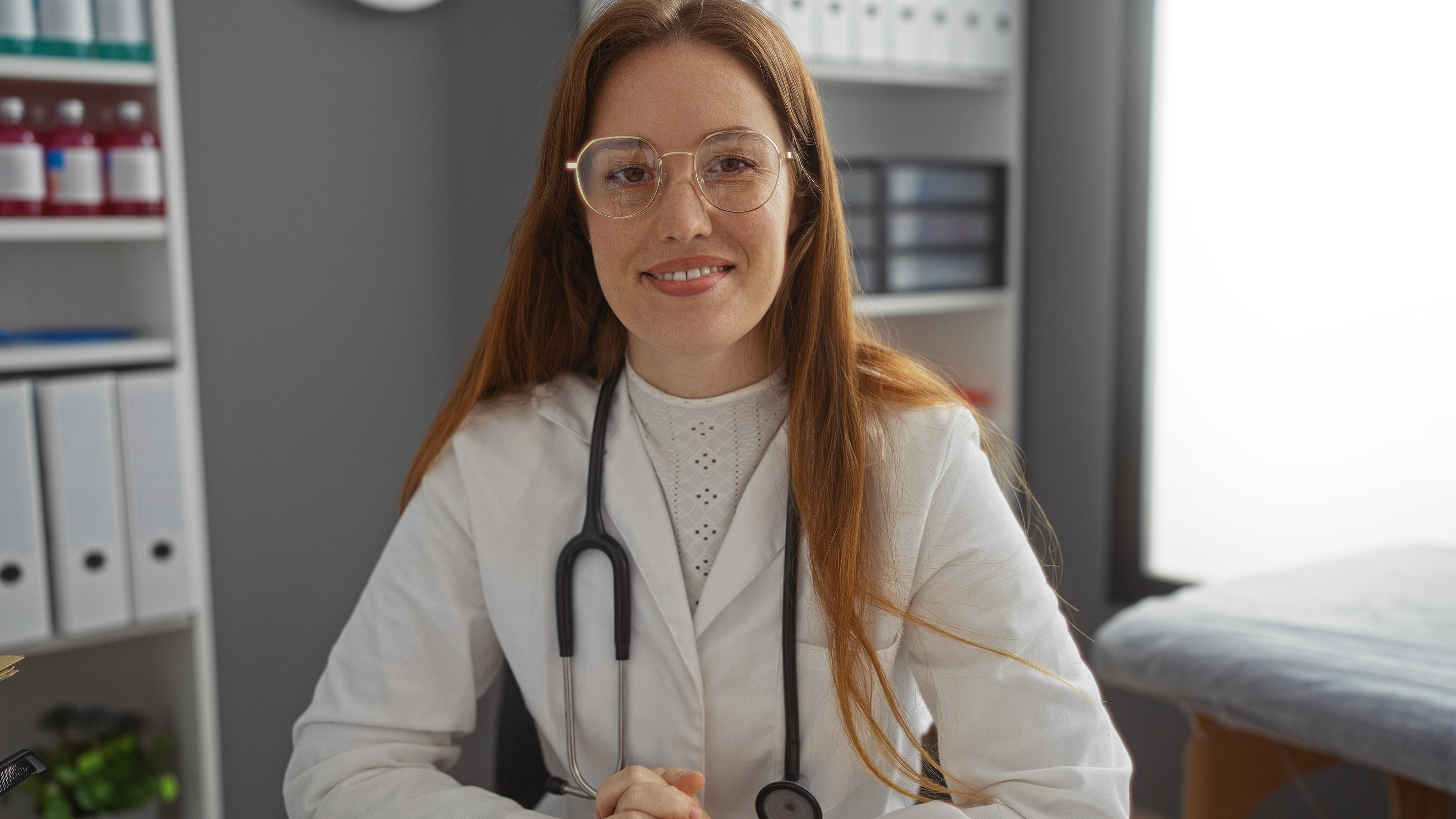 smiling nurse practitioner with glasses