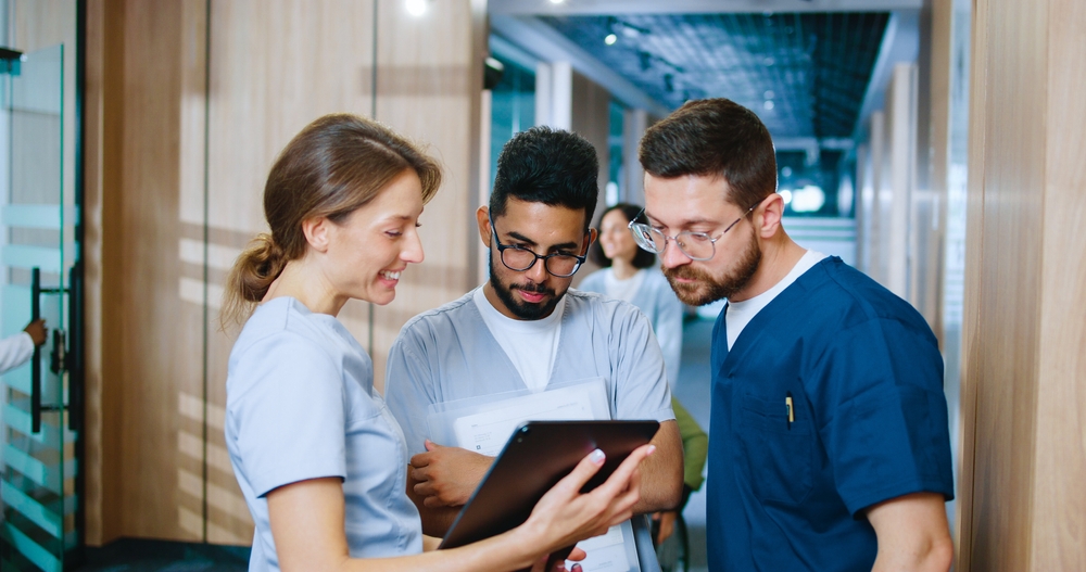 group of nurses talking with a clipboard